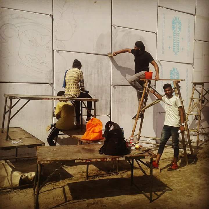 Kamaldeep Singh painting on a wall - Student of Fine Arts at LPU